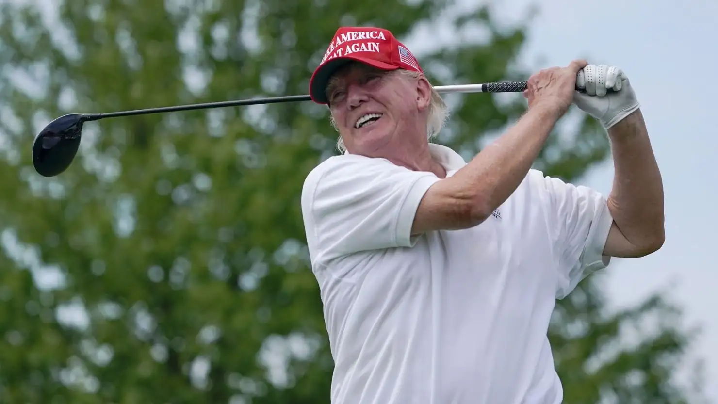 Donald Trump playing golf, showcasing his passion for the sport.